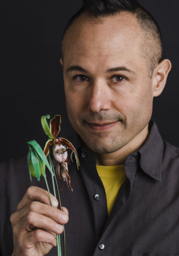 photo of Wesley Fleming holding Ladyslipper Orchid glass sculpture